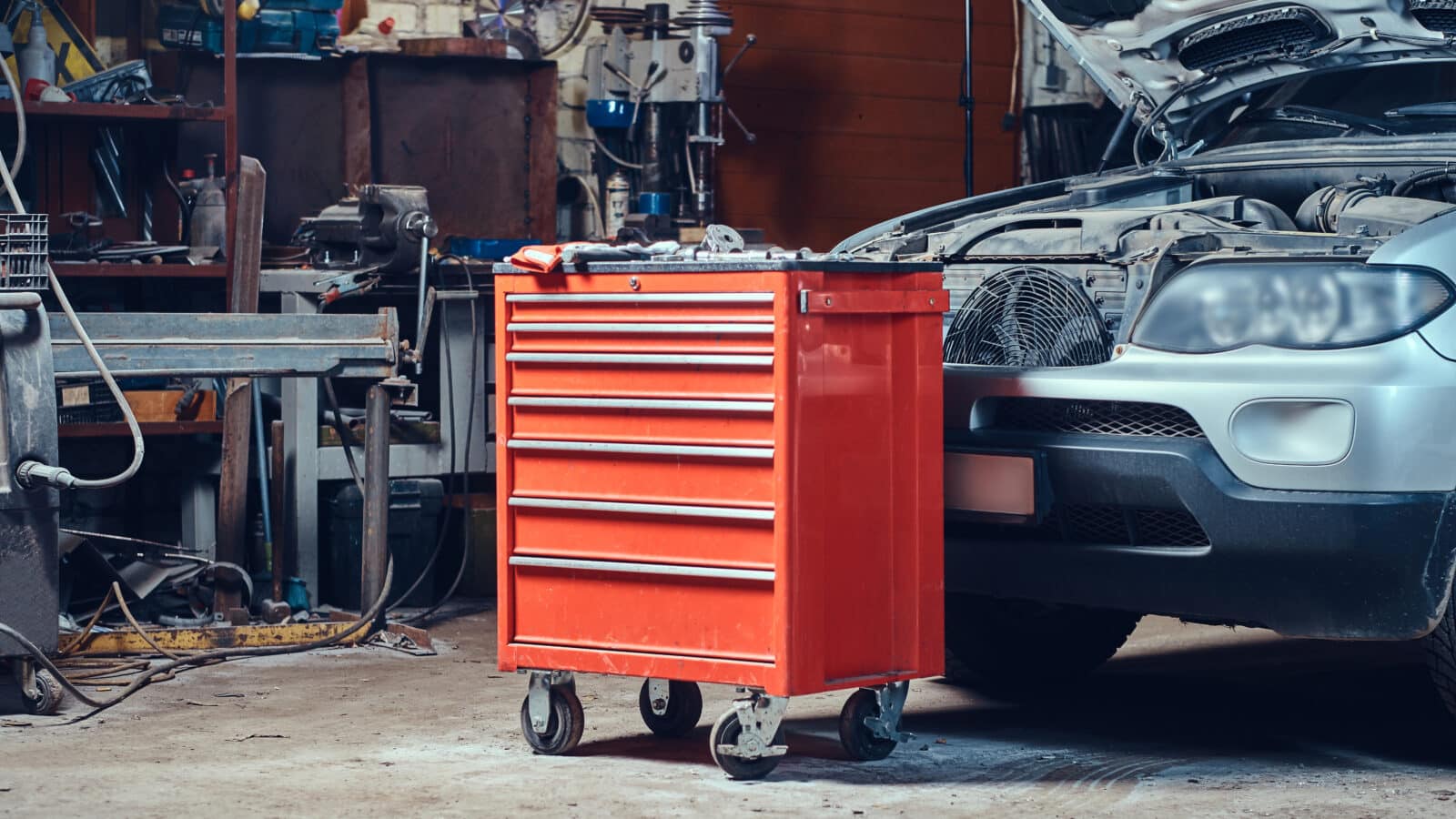 Red steel rolling tool box and cabinet used for budget garage storage
