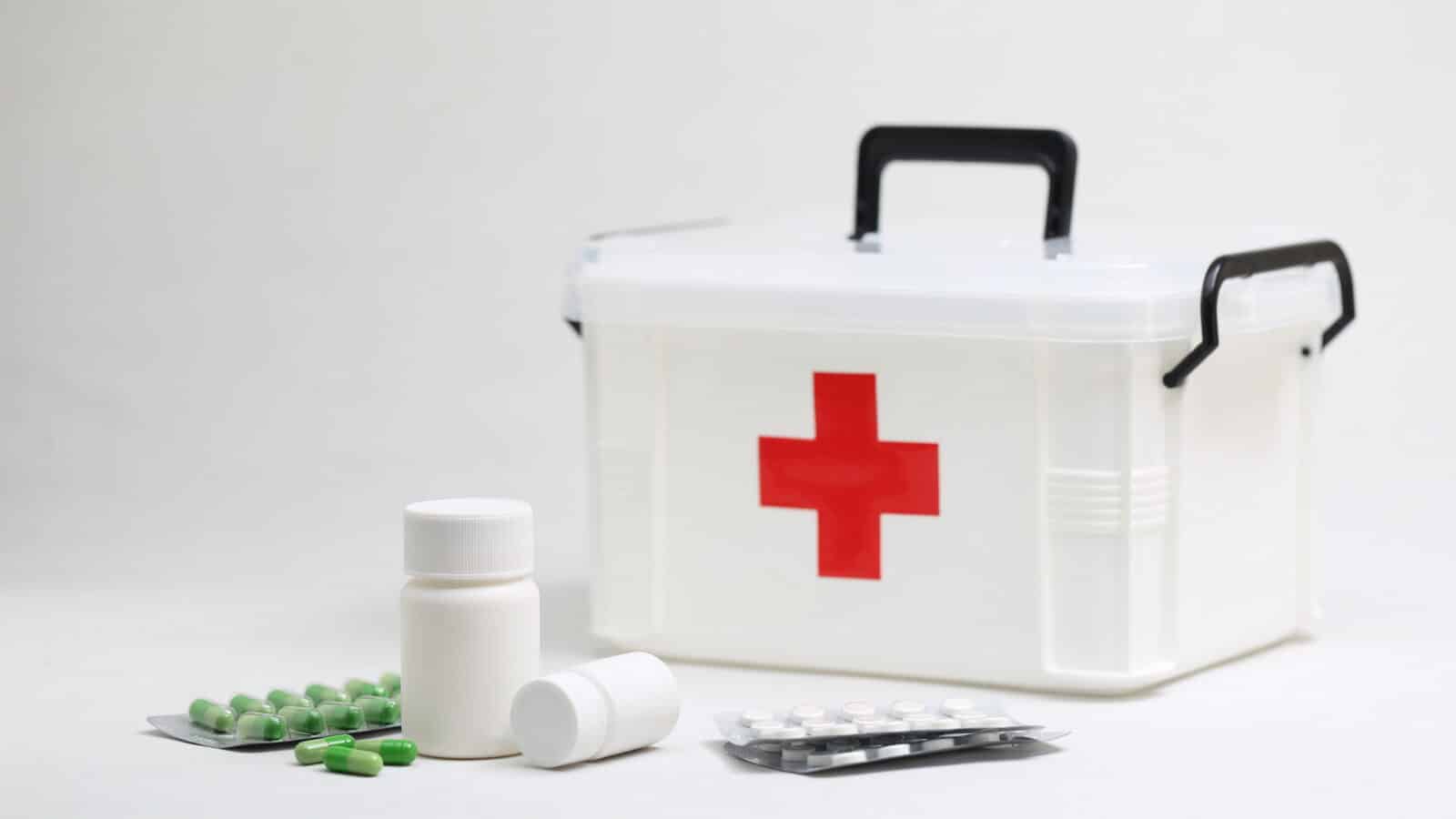 Armoire à pharmacie organisée avec boîtes de médicaments et trousse de premiers secours