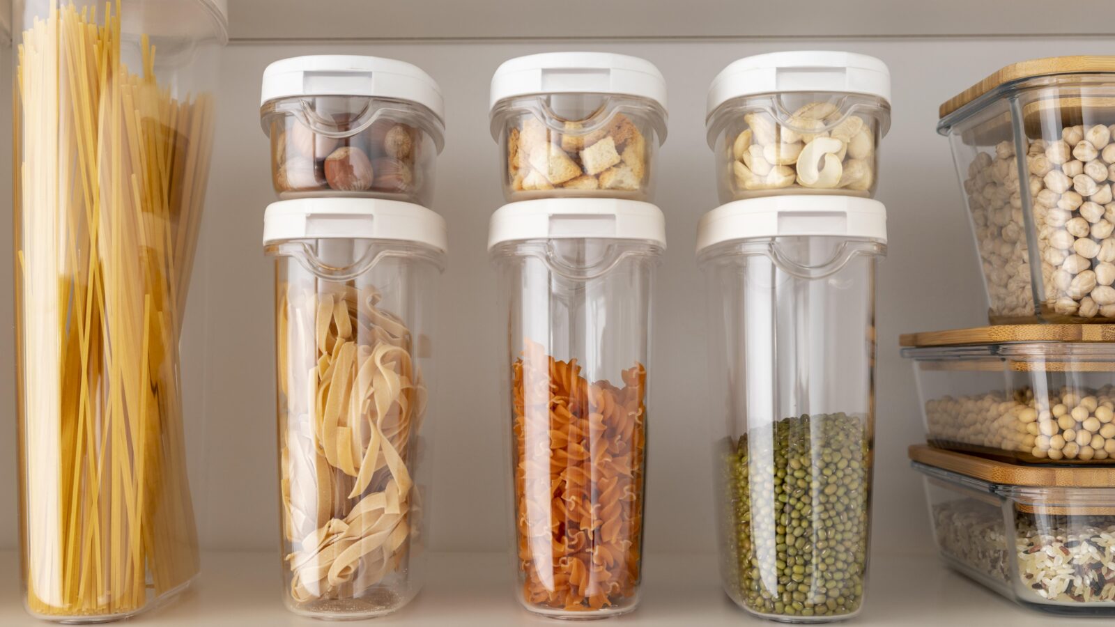Food storage containers organized and stacked neatly on a kitchen shelf