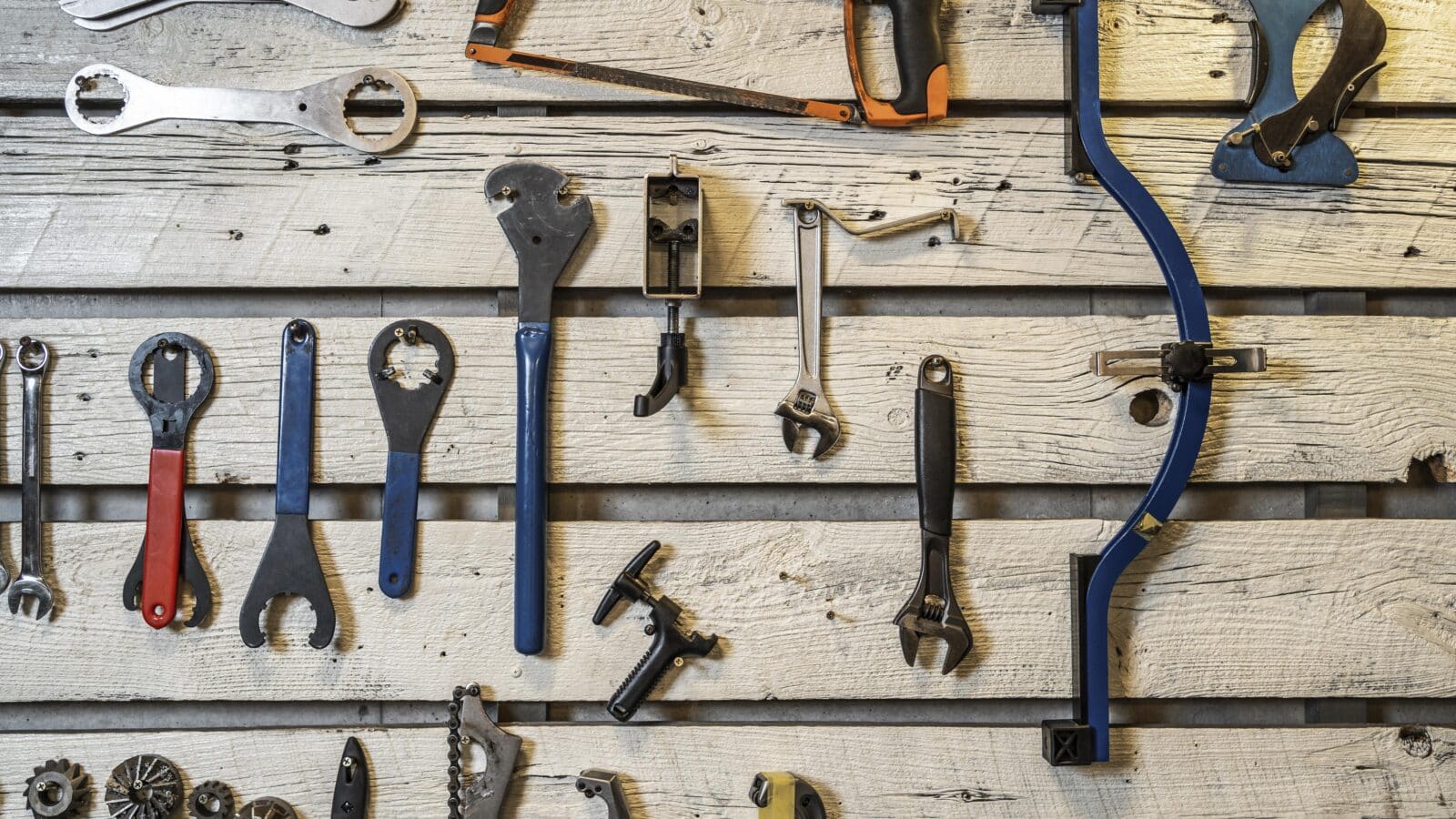 Hand tools arranged neatly on a garage workbench surface