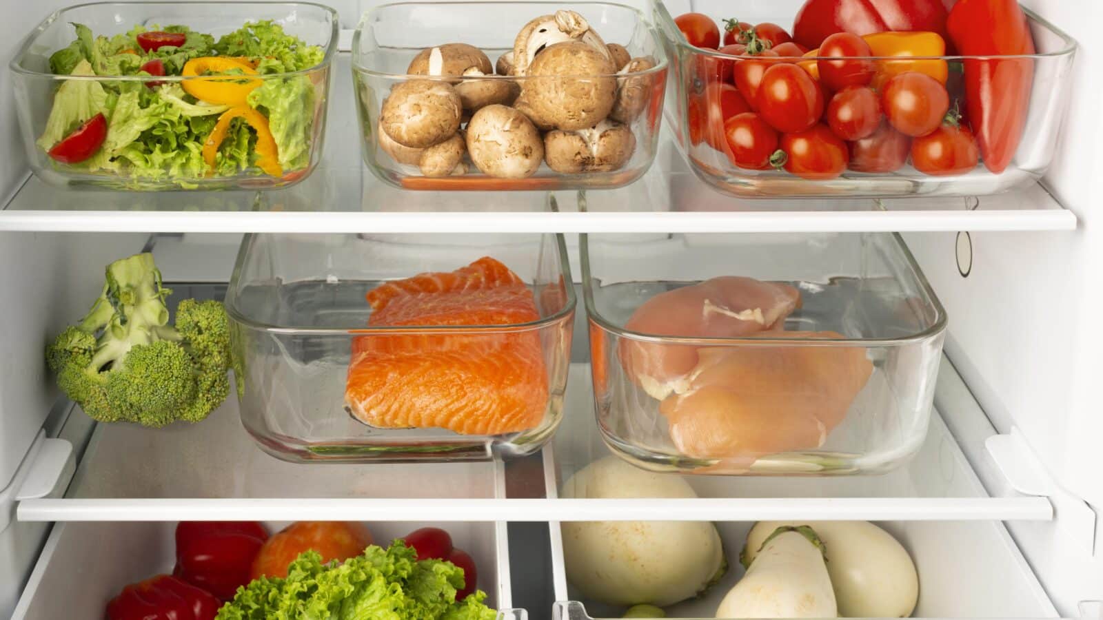 Organized refrigerator with food sorted into clear bins by category