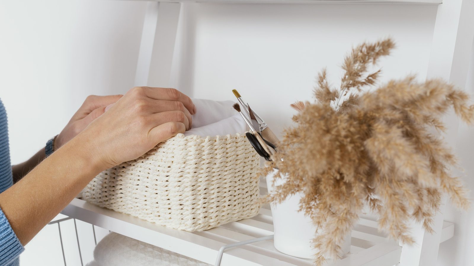 Organized bathroom cabinet with neatly arranged storage bins for toiletries