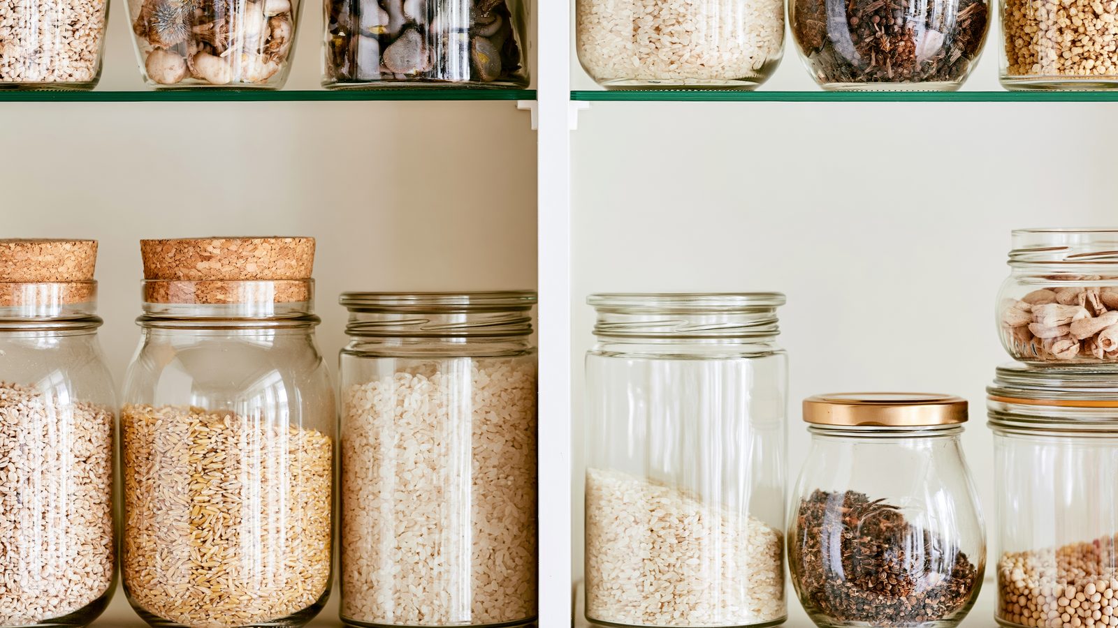 Minimal pantry shelf with labeled glass jars storing dry food staples