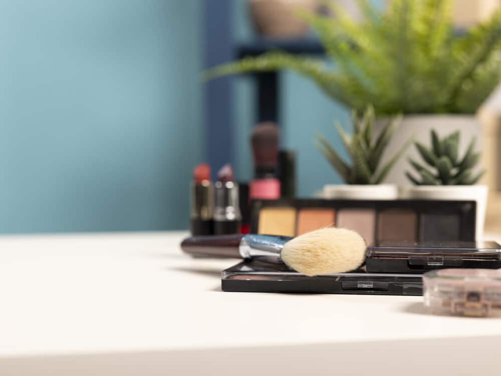 Cosmetics and skincare products arranged neatly on a tray on an empty vanity desk