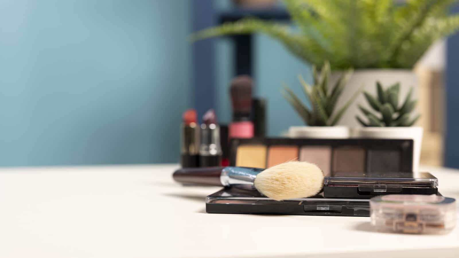 Cosmetics and skincare products arranged neatly on a tray on an empty vanity desk