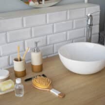 Bathroom sink counter with toiletries staged in a tray, seen from above