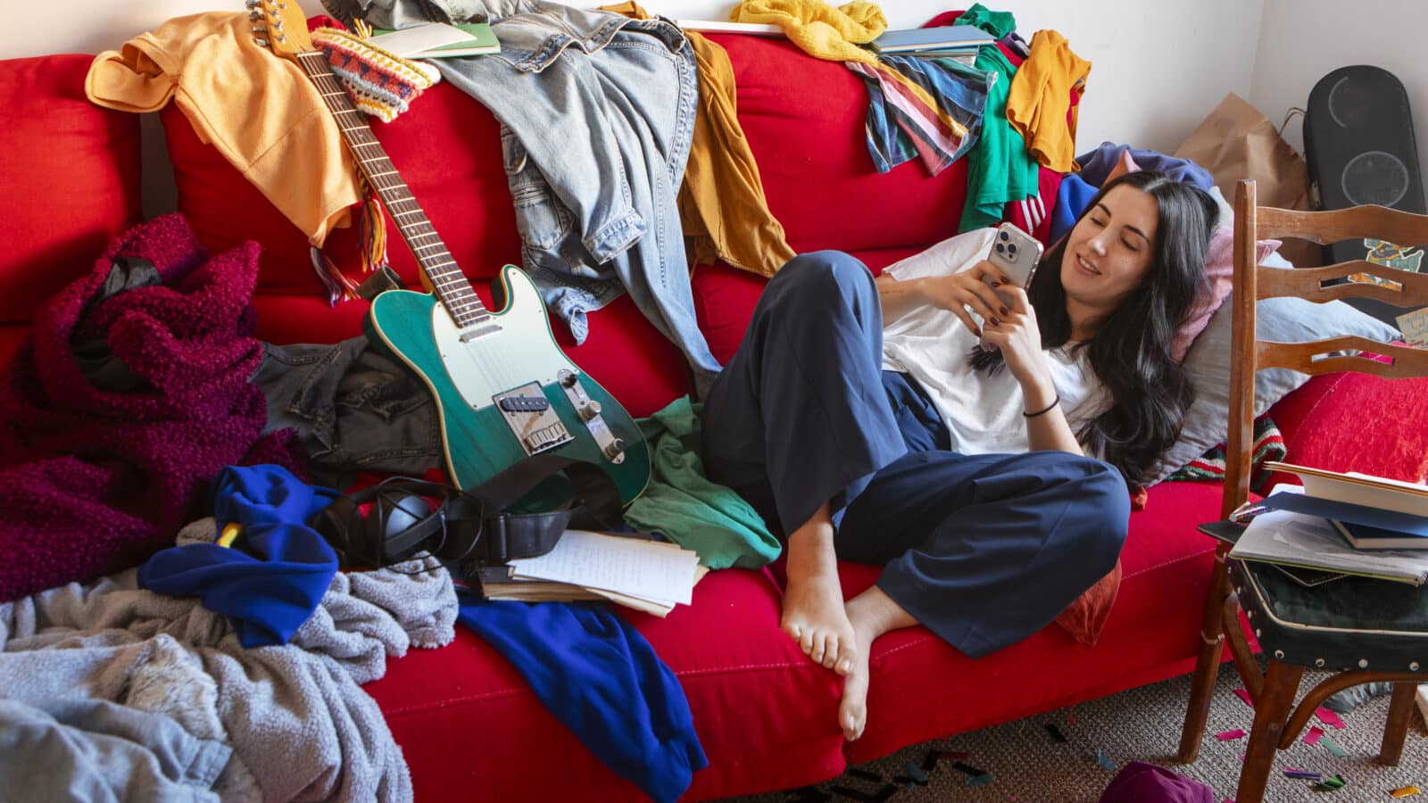 Cluttered room with clothes and belongings piled up, the kind of visible mess that builds up fast with ADHD