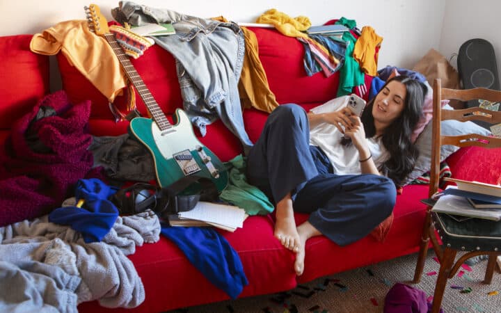 Cluttered room with clothes and belongings piled up, the kind of visible mess that builds up fast with ADHD