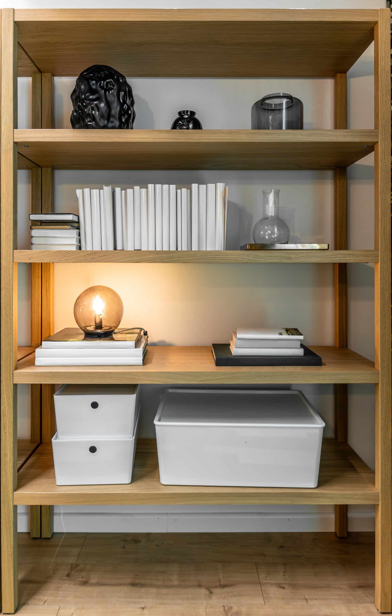 Open shelving with visible labeled storage boxes instead of a closed cabinet
